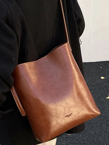 Large brown leather shoulder bag with a minimalist design for casual daily commuting