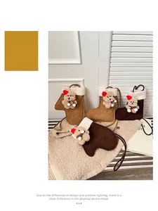 Detailed macro view of plush Christmas boot bags with 3D teddy bear ornaments and rope straps