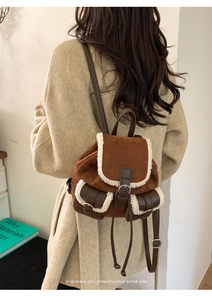 Retro plush backpack detail showing brown suede and cream fleece trim on beige coat