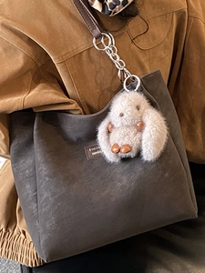 Minimalist grey frosted tote bag with chain strap and plush rabbit pendant for women