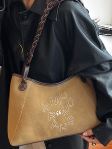 Brown suede tote bag with woven strap and white embroidery for casual daily commute