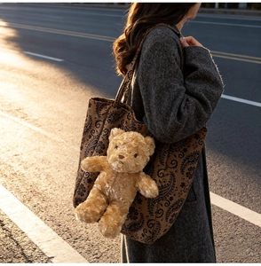 Dettaglio della borsa shopper paisley con ciondolo a forma di orsetto di peluche e luce calda