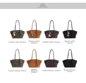 Detail view of large tote bags in green brown and black with cute heart and bear charms