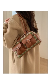 Detail showing vintage plaid patchwork textures and leather pockets on shoulder bag