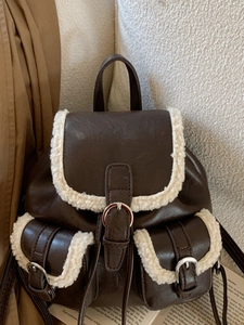 Vintage brown leather backpack with sherpa fleece trim and metal buckles for women