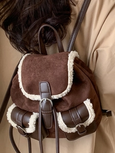 Vintage brown suede backpack with white plush faux fur trim and adjustable straps