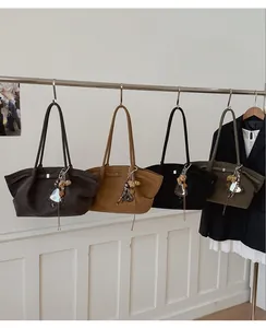 Detail of minimalist vintage tote bags in dark coffee, caramel, black, and olive green colors