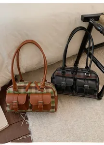 Close-up of vintage wool underarm bags in plaid design with dual front metal pockets