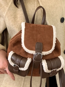 Brown suede backpack with white plush faux fur trim and vintage metal buckles