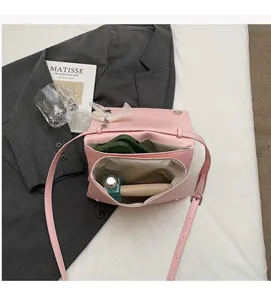 Top view of pink crossbody bag with two internal compartments for phone and makeup
