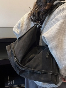 Large black tote bag with white contrast stitching in a minimalist shoulder carry style