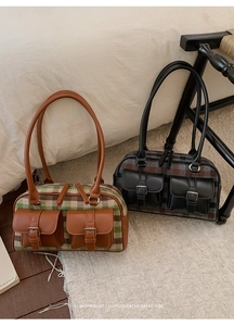 Detail view of vintage plaid shoulder bags with leather patchwork and front flap pockets