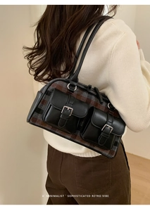 Detail of retro plaid shoulder bag with leather straps and front buckle pockets