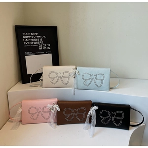 Collection of mini leather bow purses in white, blue, pink, brown and black with lace charms