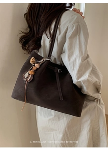 Close-up of the vintage brown tote bag texture and decorative leopard print tassel pendant