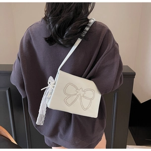 White minimalist square bag with bow rivets and delicate lace pearl hanging charms