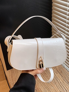 Chic white patent leather crossbody bag with elegant gold padlock and sleek top handle