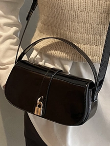 Fashionable black patent leather square shoulder bag with a stylish gold padlock buckle