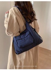 Deep blue nylon tote bag showing its large capacity and waterproof fabric detail