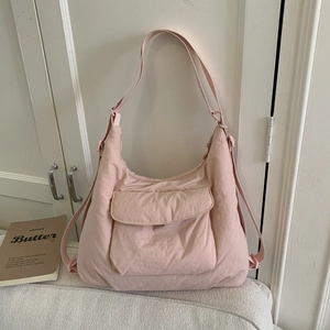 Detail view of pink large capacity canvas tote with adjustable strap and front flap pocket