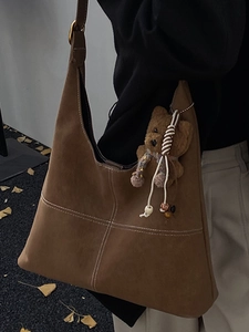French vintage dark brown suede tote bag with white cross stitching and teddy bear charm
