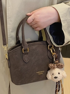 Retro dark brown matte small handbag with golden lettering and plush dog charm detail