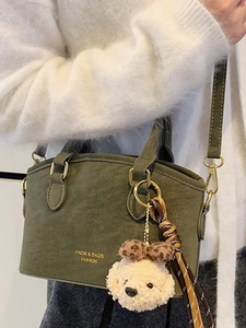 Olive green vintage crossbody bag with cute teddy bear charm and stylish logo print