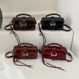 Detailed display of four retro rectangular crossbody bags in brown, black, caramel and wine red