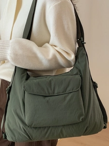 Minimalist large capacity dark green crossbody tote bag with adjustable strap and front pocket