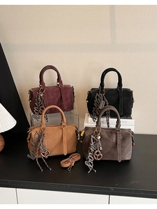 Detail of four matte faux leather Boston bags in burgundy, black, camel, and grey colors