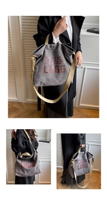 Detail view of large grey canvas tote bag with DILS LOGG logo and adjustable straps