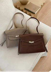 Detail showing the textured lychee grain leather and silver twist-lock on tote bag
