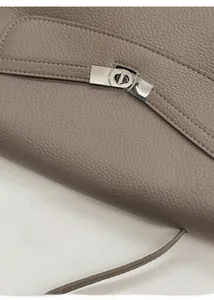 Close-up of elephant gray lychee leather tote bag with silver Kelly style lock and fine stitching