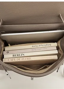 Spacious interior of vintage brown leather tote bag showing tablet and book storage