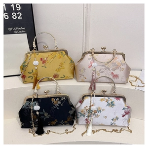 Close-up of vintage shell bags with floral embroidery, metal frames, and pearl tassels