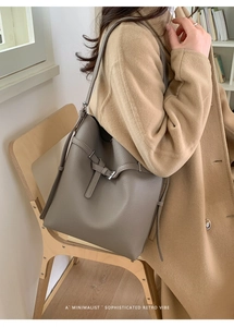 Detail der grauen Bucket Bag aus Litchi-Leder mit verstellbarem Riemen an der Schulter