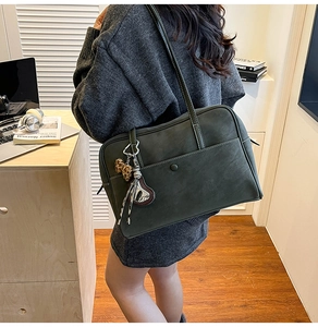 Deep green faux leather tote bag for work with leopard bow and metal charm detail