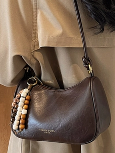 Minimalist deep brown semi-circle saddle bag with bohemian beaded tassel decoration