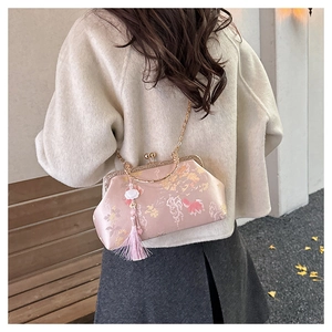 Detail of pink silk hanfu bag with golden floral embroidery and long silk tassel