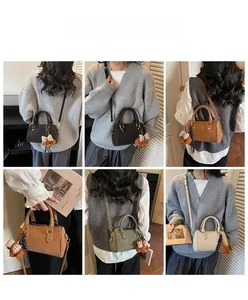 Detailed views of vintage Boston bag in multiple colors with bear pendant charm accessory