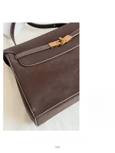 Detailed macro view of retro brown leather tote with a vintage golden metallic buckle