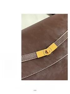 Close-up of premium brown leather texture with elegant gold twist-lock hardware on bag