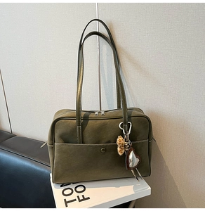 Olive green suede tote bag detail featuring double zippers and heart leopard print charm