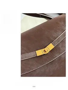 Macro view of brown leather tote bag with elegant golden rectangular twist lock closure