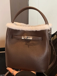 Dark brown leather bucket bag with white faux fur trim and silver turn-lock closure