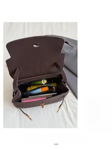 Macro view of vintage brown tote bag interior showing large capacity and zipper pocket