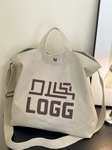 Minimalist off-white canvas tote bag with brown LOGG print and adjustable shoulder strap