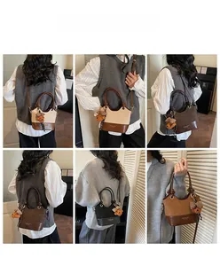 Contrast panel tote bag shown in multiple colors with bear charm and adjustable strap