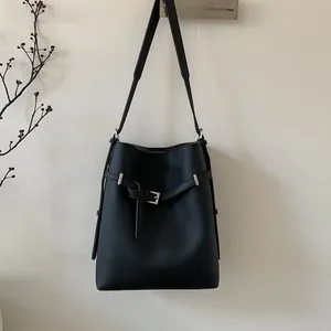 Detail der schwarzen Beuteltasche aus genarbtem Leder mit Schnalle und verstellbarem Riemen