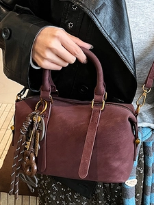 Burgundy matte Boston bag with woven tassel and gold hardware for winter fashion